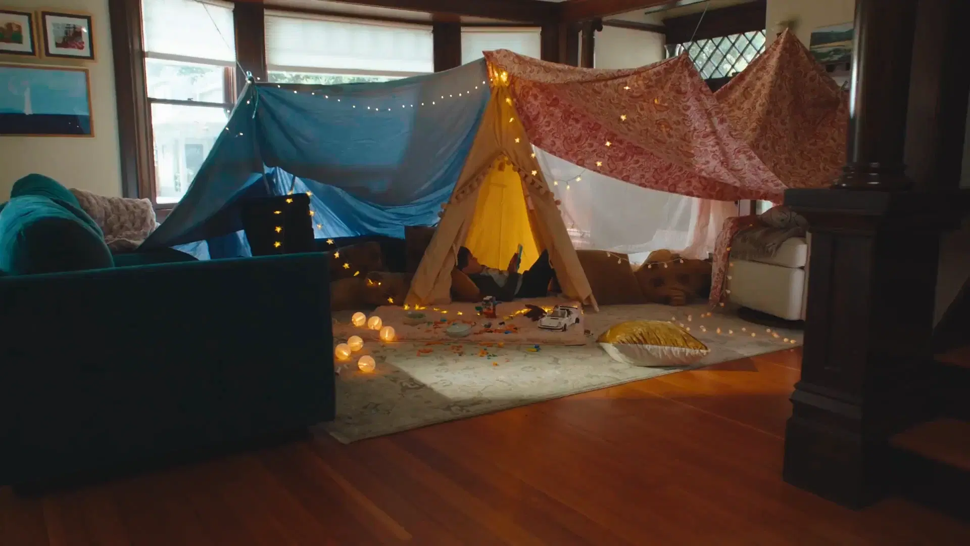 A living room blanket fort with Matic nearby